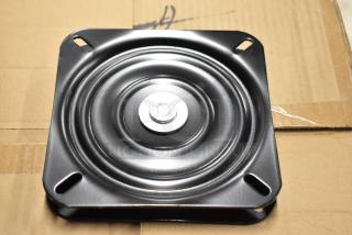 Black metal swivel plate, new condition, circular design with central screw, four corner mounting holes, on cardboard.
