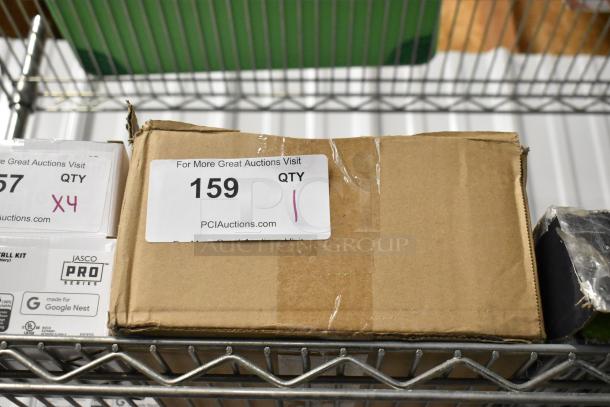 Cardboard box labeled "159" with PCI Auctions details, quantity "1," on a metal shelf. Box appears sealed and intact.