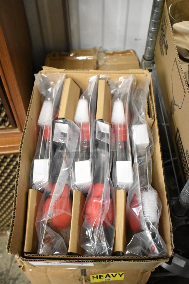 Box of five red and white cleaning brushes, new in packaging. Each with a plastic handle, packaged in a cardboard box.