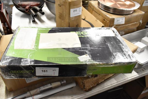 Regency box with partially removed white label, auction tag 161, taped edges, possibly containing kitchen equipment.