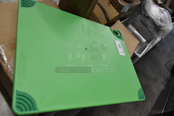 Green cutting board with textured corners and visible scuff marks, labeled "762." Suitable for kitchen use.