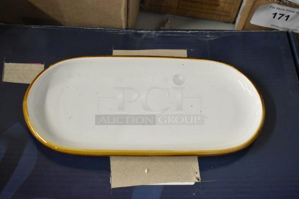 Ceramic serving platter with white glaze and brown rim, gently used, light speckling, no visible markings or labels.