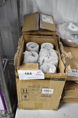Box of 14 oz amber stemless wine glasses, 12 per case. Cardboard box showing signs of wear. Auction tag number 164.