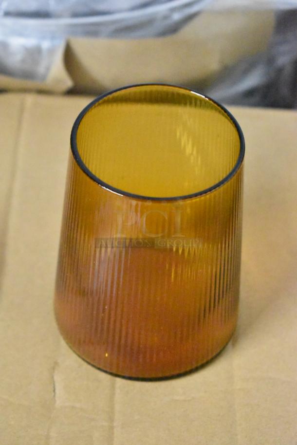 Amber ribbed glass vase, conical shape, excellent condition, approximately 6 inches tall, ideal for decorative use.