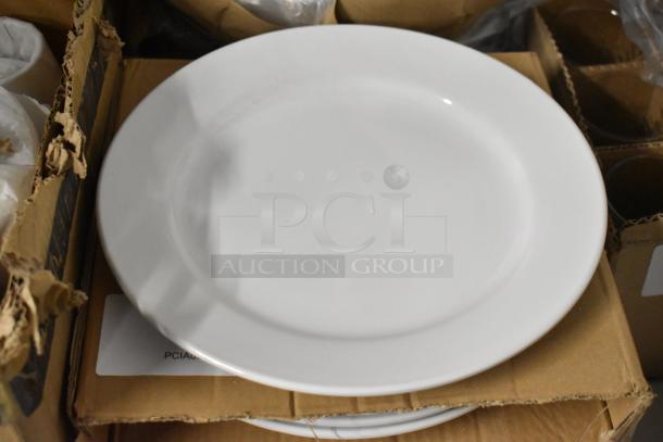 White ceramic dinner plate, smooth finish, good condition, placed on cardboard packaging, no visible markings.