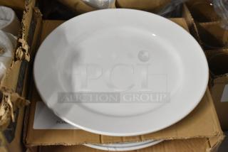 White ceramic dinner plate, smooth finish, good condition, placed on cardboard packaging, no visible markings.