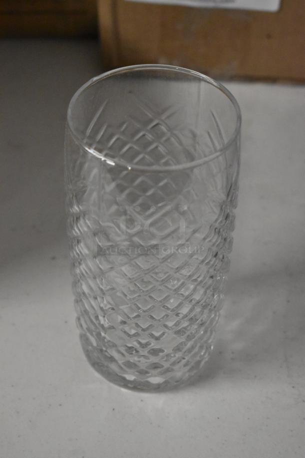 Clear glass tumbler with a diamond pattern design. In excellent condition, standing on a white surface.
