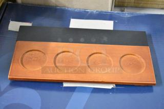 Wooden coin holder with four circular indents on a rectangular base. Good condition, no visible markings or labels.