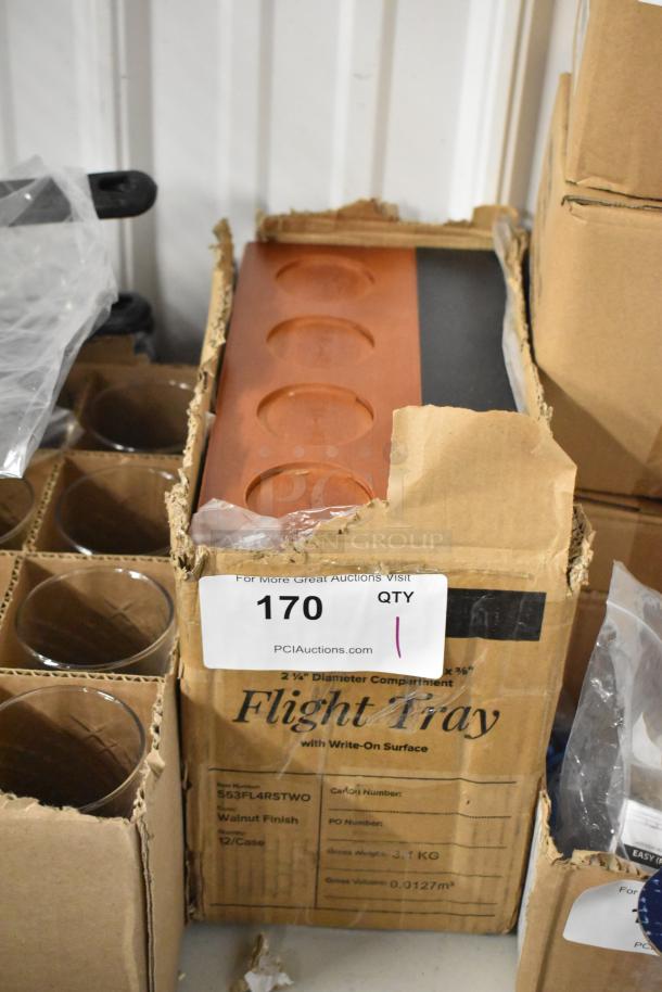 Boxed flight tray with walnut finish, featuring compartments, new in packaging. Auction tag reads "170 PCI Auctions."