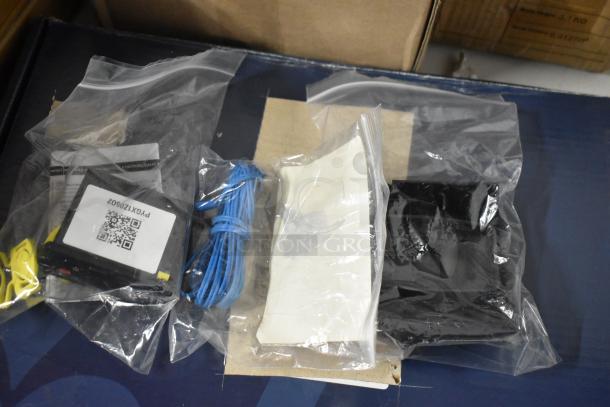 Electronic components set in plastic bags, includes a device with a label "PYXK12S602", blue cable, and instructions. New condition.