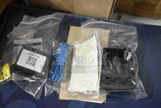 Electronic components set in plastic bags, includes a device with a label "PYXK12S602", blue cable, and instructions. New condition.