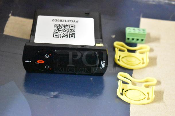 Carel electronic thermostat with display, QR code label "P/N: PCG1X120S0Z," includes yellow brackets and green connector.