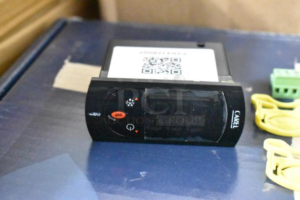 CAREL digital thermostat, model number FDX7720027, with display and control buttons, in excellent condition.