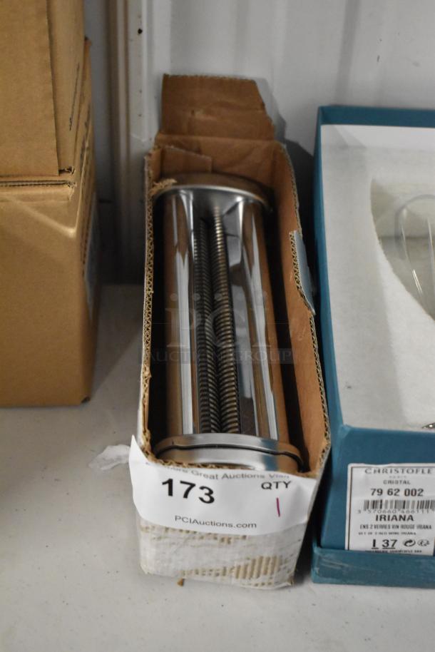 Metallic cylindrical pasta cutter in box, pristine condition, auction label "173," from PCIAuctions.com, ready for bidding.