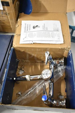 Chrome faucet mixer in original packaging with installation guide. Features dual handles, new condition, minor box wear.