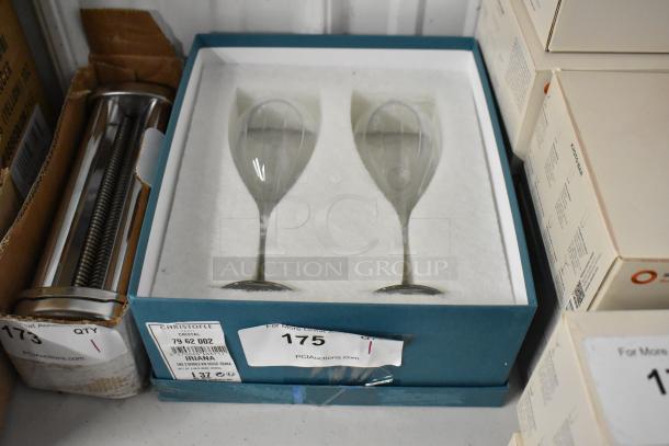 Set of two Christofle Triana crystal wine glasses in original box, condition like new. Label indicates model number 79 62 002.