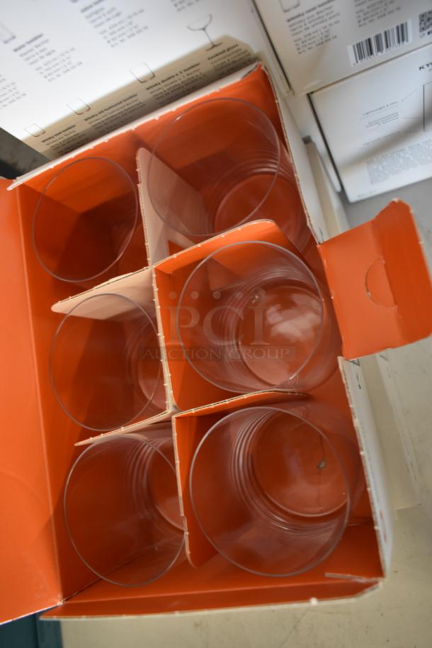 Box of six clear drinking glasses in original packaging, unused condition. Each glass is separated by cardboard dividers.