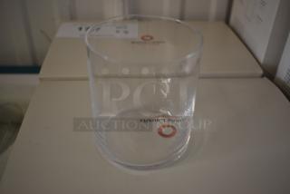 Clear glass tumbler with "Fragile Gauslitz" marking, in new condition, placed on a box.