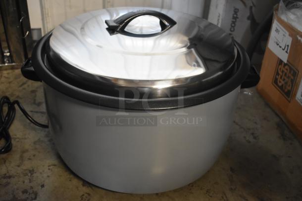 Electric rice cooker with stainless steel lid, black handle, and power cord. Appears in excellent condition.
