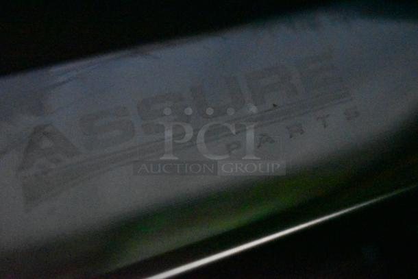 Close-up of an "ASSURE PARTS" marked metal surface, showing manufacturer branding, slight scratches visible, in fair condition.