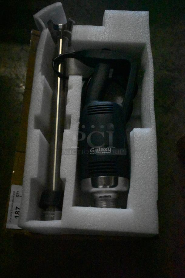 Galaxy equipment immersion blender, new in packaging, features a stainless steel shaft and ergonomic handle. Condition new.
