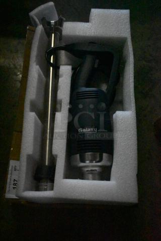 Galaxy equipment immersion blender, new in packaging, features a stainless steel shaft and ergonomic handle. Condition new.