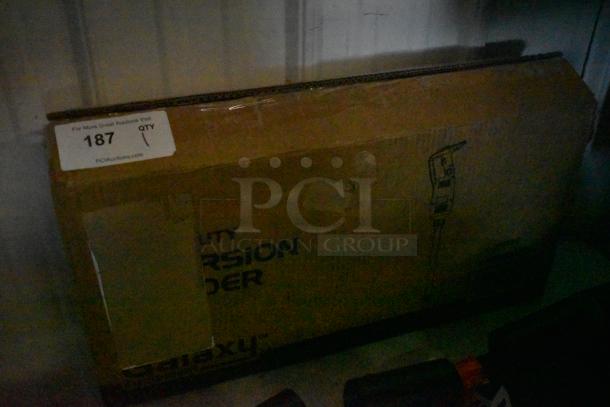 Cardboard box labeled "Heavy Duty" with a printed illustration of a tool. Auction tag reads "187," directing to PCIAuctions.com.