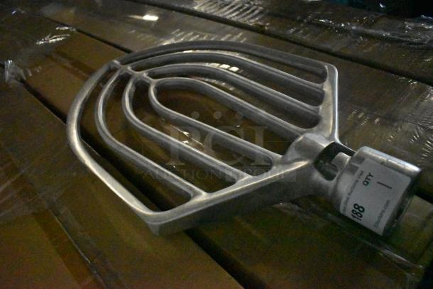 Metal stirring paddle with curved design, attached tag reading "Lot 188." Industrial-grade item in used condition.
