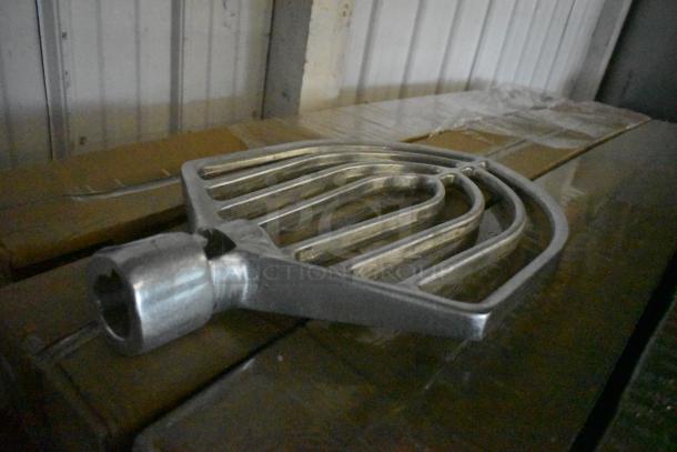 Metal industrial rake attachment, silver finish, in good condition, featuring multiple curved tines and a cylindrical mount.