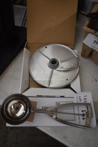 Stainless steel ice cream scoop and slicer attachment in new condition, in open box, with auction tag indicating quantity 2.