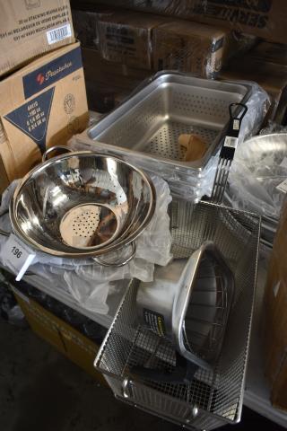 Assorted stainless steel kitchen utensils, including colander and perforated pans, in new condition with visible labels.