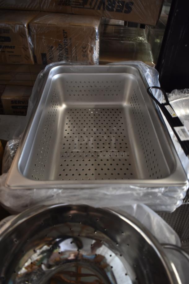 Stainless steel perforated steam table tray, new, wrapped in plastic, no visible markings, ideal for catering use.