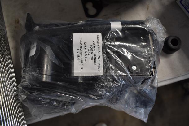 Sealed compressor NEU2178U RTS-634-2 in plastic wrap with label showing model, item number, and "Made in China."