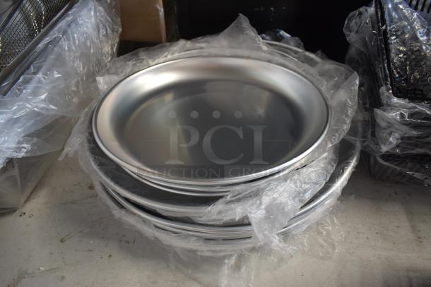 Stack of new silver metal plates wrapped in plastic, in excellent condition. Suitable for commercial or catering use.