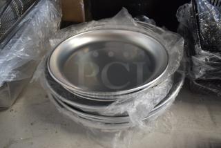 Stack of new silver metal plates wrapped in plastic, in excellent condition. Suitable for commercial or catering use.