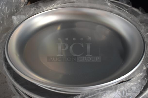 Stack of shiny, silver metal plates in new condition, wrapped in protective plastic. Smooth, reflective surface.