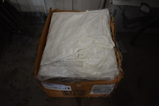 Box of white fabric or material sheets, wrapped in plastic. Box shows signs of wear with visible labels and markings.