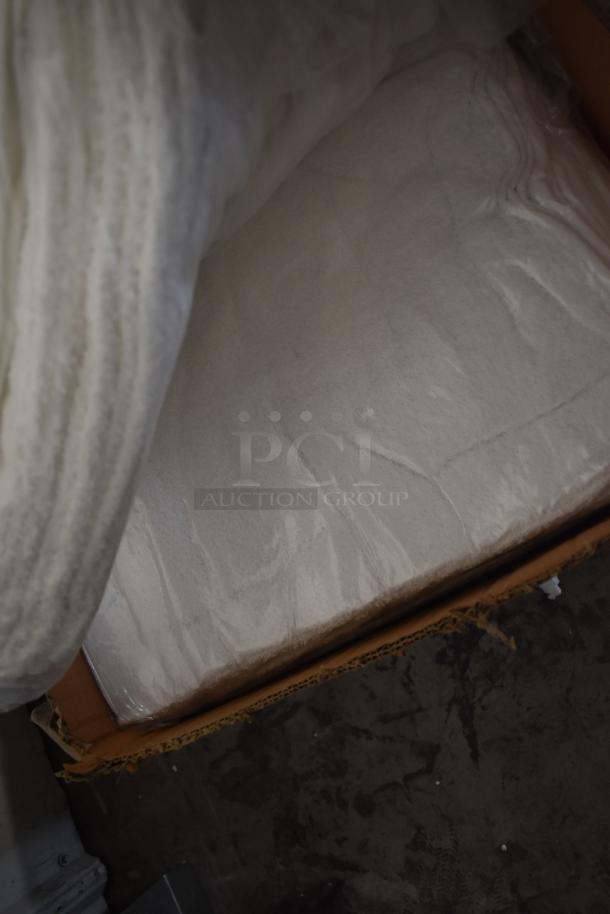 Large white textile fabric in a cardboard box. Fabric appears clean and neatly folded, suitable for crafting or upholstery.