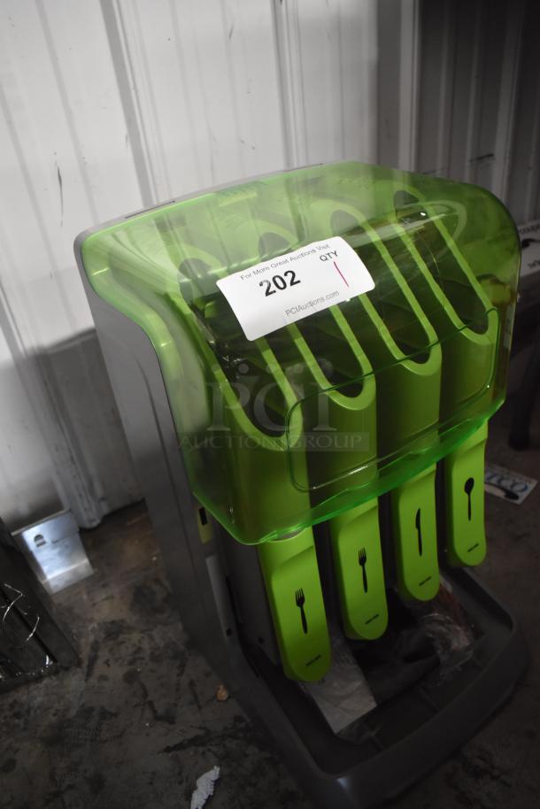 Green cutlery organizer with transparent cover, labeled "202" from PCI Auctions. Slots for forks and spoons, good condition.