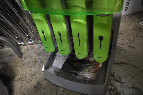 Green cutlery dispenser with slots for forks, knives, and spoons labeled with icons and "press here" text, in good condition.