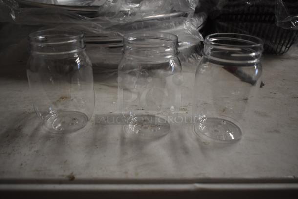 Three clear glass jars on a white surface, in excellent condition, with no visible labels or markings.