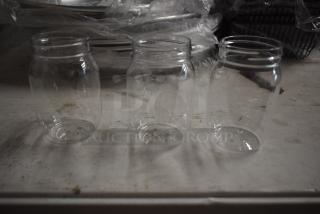 Three clear glass jars on a white surface, in excellent condition, with no visible labels or markings.