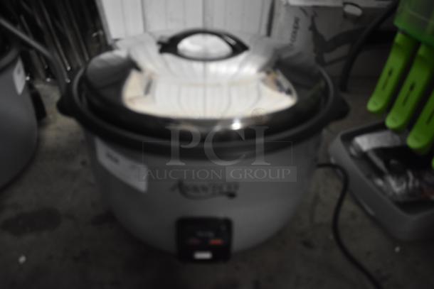 Large Aroma rice cooker with stainless steel lid; includes label and power cord; used condition.
