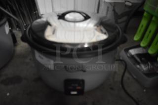 Large Aroma rice cooker with stainless steel lid; includes label and power cord; used condition.