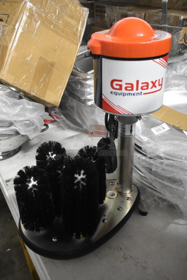 Galaxy Equipment commercial glass washer, features multiple black bristle brushes on a stainless base, in good condition.