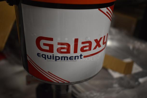 Galaxy Equipment machine part with logo, featuring red and blue text on a white background. Appears in used condition.