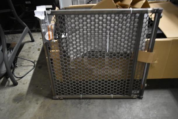 Metal mesh safety gate, in good condition, with honeycomb design. Visible tags suggest new or untouched state.