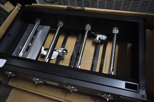 Blackstone Pro Grill frame in box, unused condition; features stainless steel burners, control knobs, and caster wheel attachment.