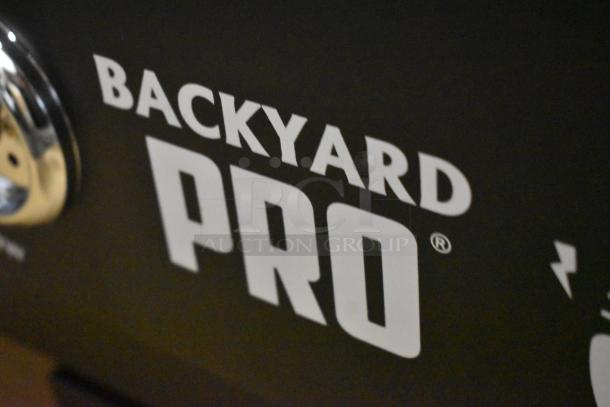 Backyard Pro branding on a grill or smoker, black surface, shiny metal component visible, indicating quality and durability.