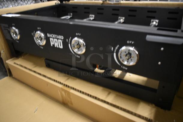 Backyard Pro 4-burner gas grill in good condition. Features stainless steel knobs with "OFF" and "LOW" labels.